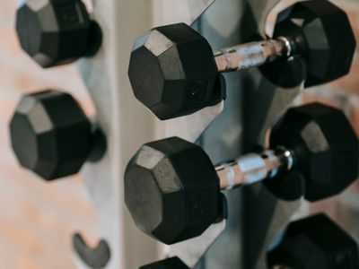 Close up of heavy dumbbells on a steel rack